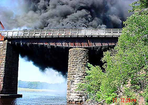 Smoke billows from the old Wallace railway bridge on 11 August 2002